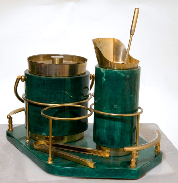 Rare complete five-piece cocktail bar serving set by Aldo Tura.  Italy, circa 1930.<br />
<br />
Features ice bucket, cocktail shaker, stirrer, ice tongs and a tray.  Includes two open spaces for liquor bottles.  Made of green goatskin and