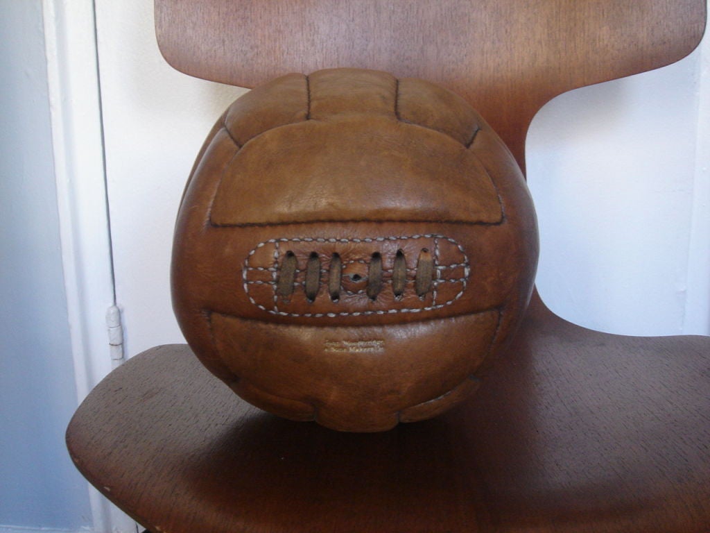 Vintage leather soccerball by John Woodbridge & Sons Makers Ltd. England, circa 1940.

Features beautiful weathered leather in Cognac brown and original lacing.  Evocative of medicine balls from the same period.  Signed with the maker's logo in