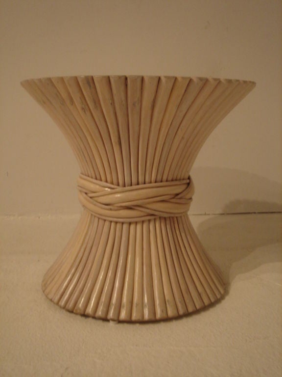 A dramatic side table in the form of a sheaf of wheat by McGuire.  USA, circa 1970.

Currently out of production. The base is handcrafted of Palasan rattan, the largest rattan grown. Natural finish.  The Palasan poles are cinched in the middle by