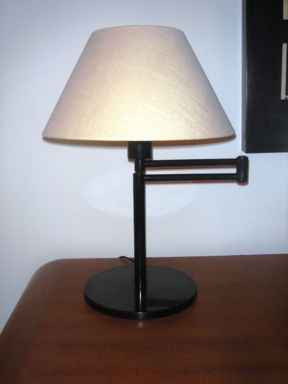 Black metal desk lamp with swing arm.  Argentina, circa 1970.<br />
<br />
Signed with maker's label.<br />
<br />
Item may be viewed at the 1stdibs showroom at the New York Design Center 200 Lexington Avenue, 10th floor, New York, NY 10016. 