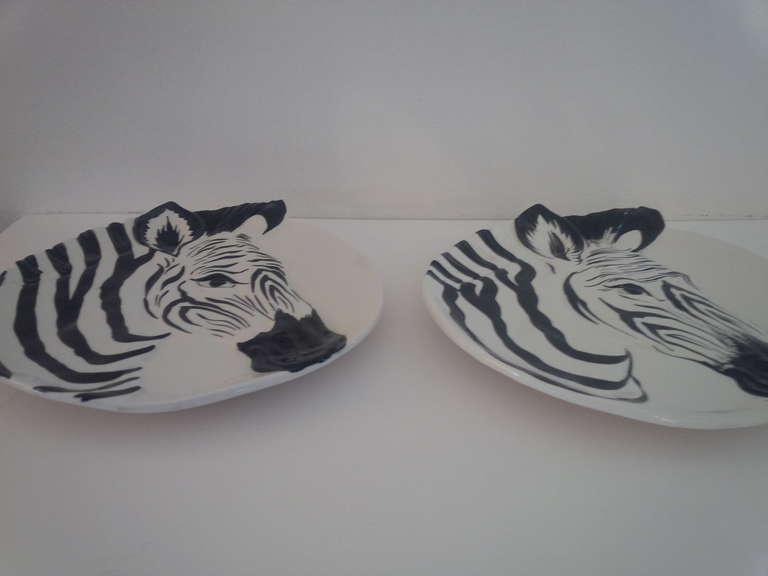 Pair of glazed ceramic plates with a relief zebra design. Signed.  Made in Italy for Bonwit Teller. Circa 1970.