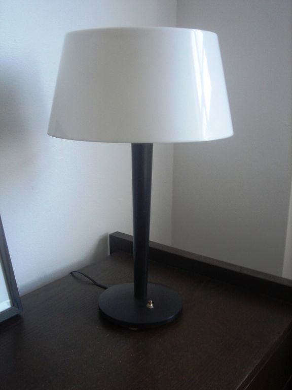 Black lamp with white shade by Gerald Thurston for Lightolier.  USA, circa 1950.  Two available; priced individually.

23 inch height
14 inch shade diameter at widest point
7.25 inch base diameter