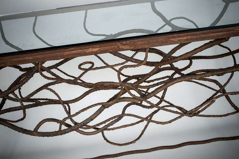 Fantastic console, full of movement and texture.  Hand wrought and twisted iron that is then textured with iron application to give the impression of grape vines.

Casts fantastic shadows on the floor when lit with a  table lamp.