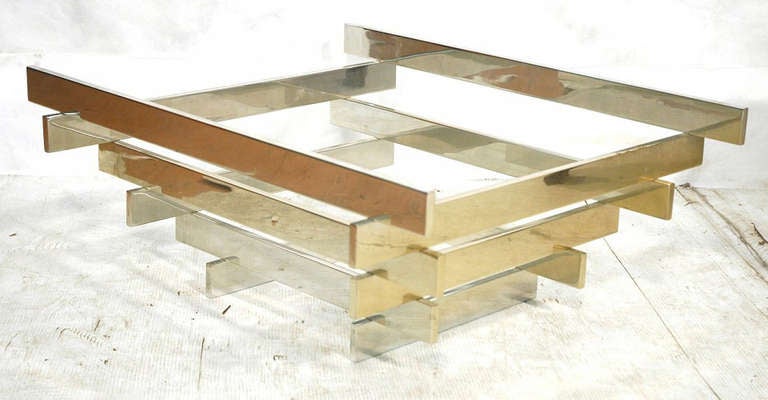 Chrome and glass cocktail table by Paul Mayen for Habitat.  USA, circa 1960.

Made from flat stacked bars of chrome-plated steel. Base measures 30 inches by 27 inches. Includes glass top (not shown) which measures 36 inches by 36 inches.