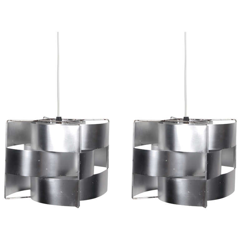 Pair of signature light fixtures by Max Sauze.  France, circa 1970.  Made of spun aluminum panels woven onto a metal frame.  Rewired; each fixture takes a single 60 watt max bulb.