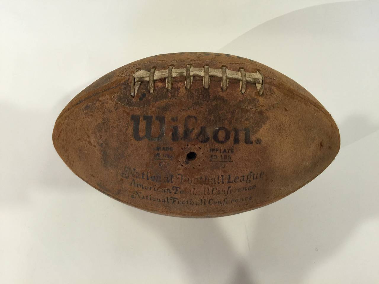 Early pigskin leather football by Wilson, USA, circa 1940.