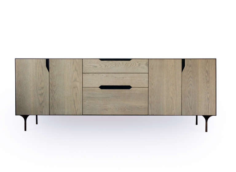 Inspired by the Greek legend, the Titan credenza projects a masculine aesthetic given by the use of materials and its proportions; a heavy steel carcass embraces a wooden body, all suspended by a tapered steel legs; giving the credenza a feeling of