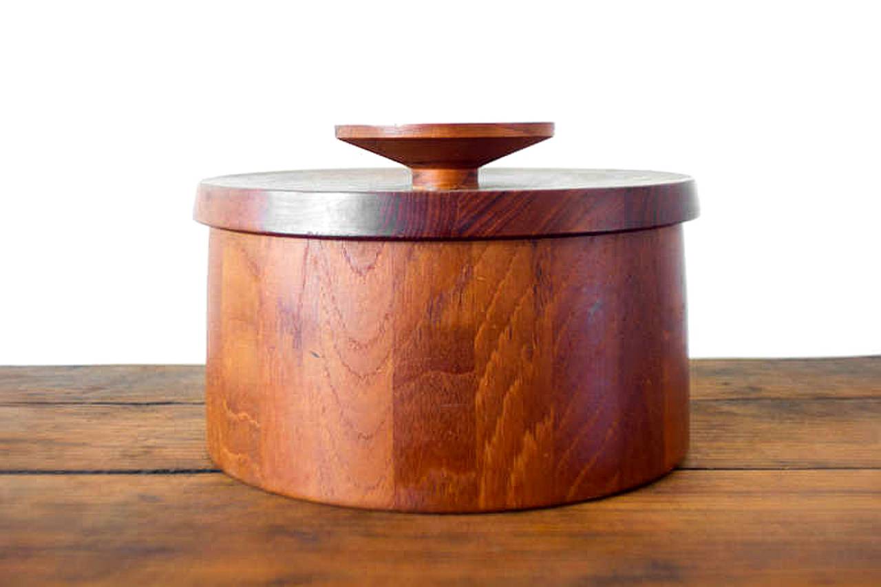 This elegant teak ice bucket is an early design by Quistgaard for Dansk. The bucket flares slightly toward the base, and the lid features a subtle concave.