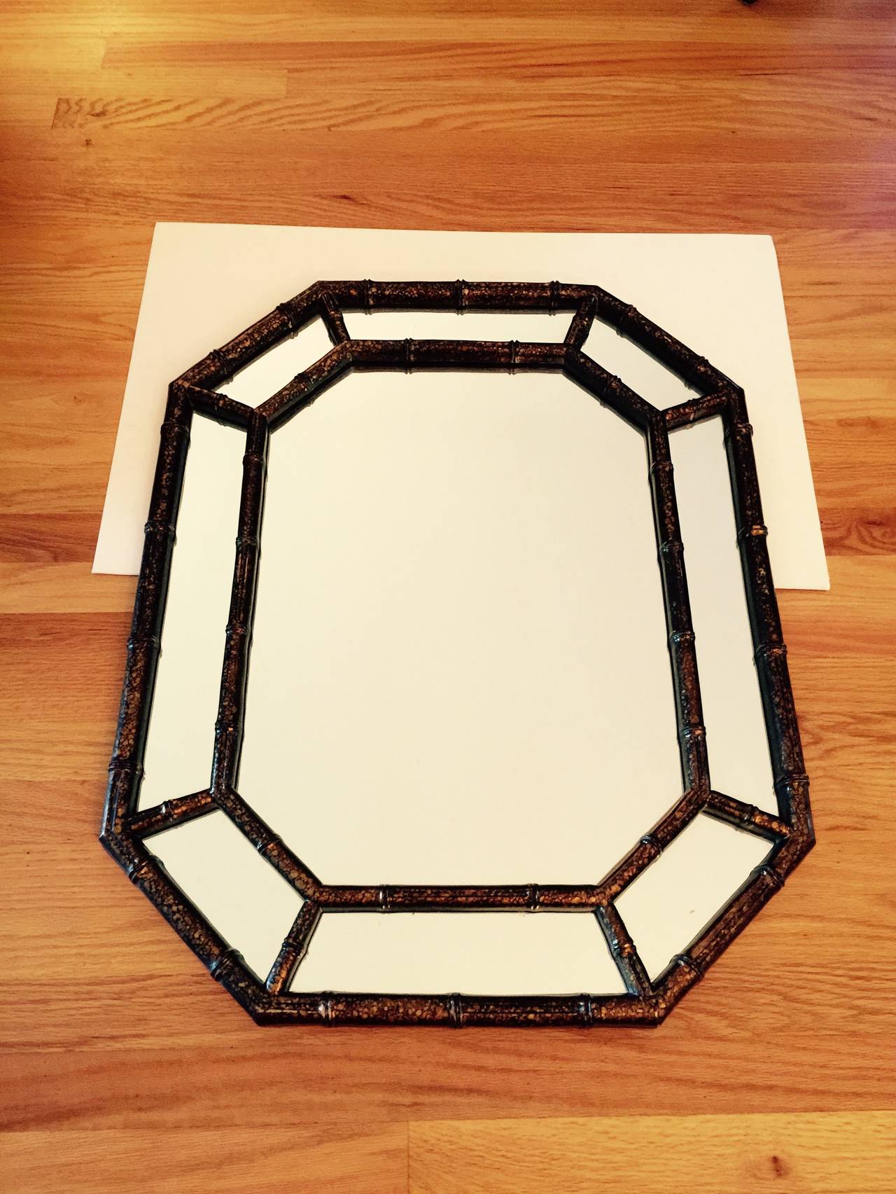 Faux tortoiseshell oil drop wall mirror. Octagonal wood frame. Hangers on back allow hanging vertically (as shown in photos) or horizontally. Minimal age wear. No maker's mark.
