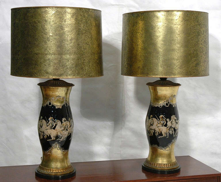 These mid-century modern Piero Fornasetti glass table lamps feature lithographically printed 19th century images of Roman soldiers on horseback set off against a gold foil and india ink background. Matching original drum shades. -- Dimensions: H: 36