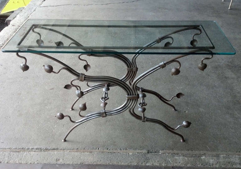 Fantastic foliate-form wrought iron console table. Hand made with excellent attention to quality and detail. With it's petite footings and interlocking vine stretchers this piece is graceful and very well made. Height 27 1/2 Inches Length 50 Inches