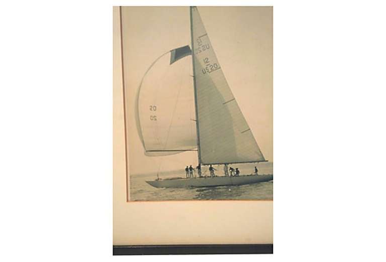 Vintage black and white sailing photograph.  USA, circa 1964. 

Depicts the Constellation sail boat, America's Cup Winner 1964.  Displayed in original black wood frame with mat.