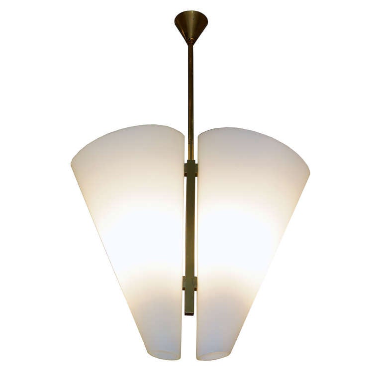 Fontana Arte Chandelier
Italy, c. 1960.

Two white satin finished glass conical shades. Brass shows beautiful, age appropriate patination.
27.5″ high, 16.5″ wide, 6″ deep.
All original, excellent vintage condition.

Documentation as to model number