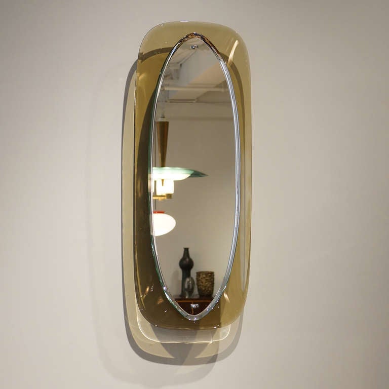 Amber Italian Mirror

Oval beveled mirror fixed with two chrome mounts in a warm amber / gray glass frame.
Maker unknown, Fontana Arte quality construction.
Italy, c. 1950
Excellent original condition

34