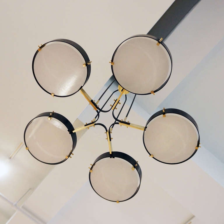 5 light chandelier by Stilnovo. Brass with black enamel and white glass diffusers. Beautifully restored and rewired, takes five candelabra bulbs. Price does not include shipping. For more information and to see our complete inventory visit our web