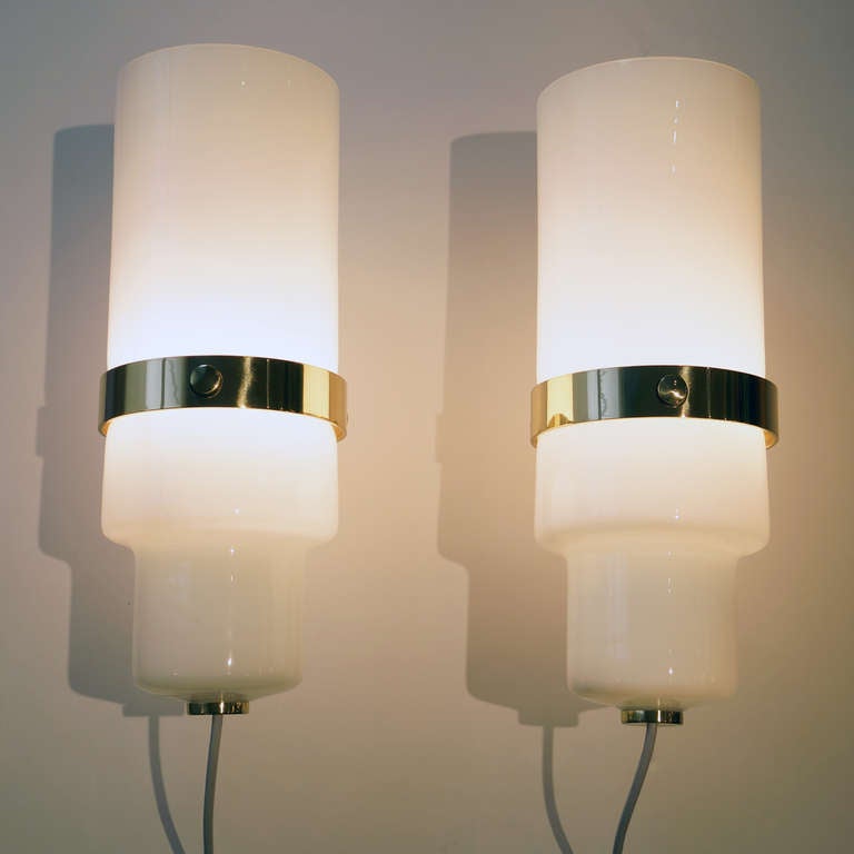 Pair of sconces by Gino Sarfatti for Arteluce, Italy, circa 1960. Model number 246. Brass mounts with white glass diffuser. Brass repolished, recently rewired. Signed with Arteluce Milano tag. Documented.

Measures: 15
