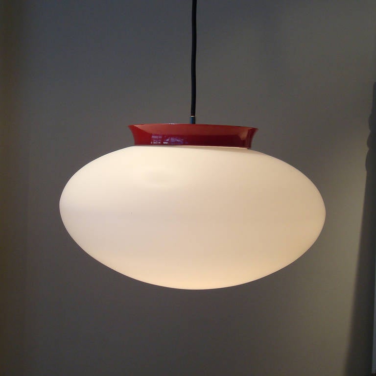  Pendant lamp designed by Alessandro Pianon for Vistosi. Italy, circa 1960. Satin finished, white cased glass, each pendant takes a single bulb.
Documented in Lampada, by Franco Magnani, pg 22
Red pendant 10" High, 15" Diameter

Black