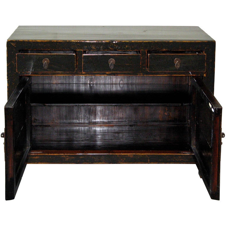 Antique black buffet with rubbed edges exposing the wood. Can be placed behind a sofa or in an entry way for an elegant accent. New hardware and interior shelf.