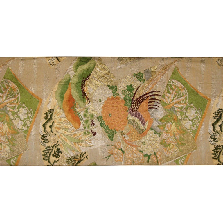 Vintage Japanese obi from Kyoto was worn by women for formal wedding ceremonies as a kimono sash. Maru obi is the most formal of the obis and was used for weddings. Peacocks resting on chrysanthemums are surrounded by the friends of winter or