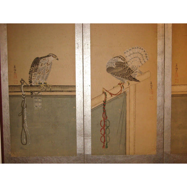 Antique six-panel Japanese screen depicting hunting hawks with colorful tethers. Ink and color on rice paper with silver leaf surround. Remounted on silver leaf with original wood frame. Meiji period, circa 1885.