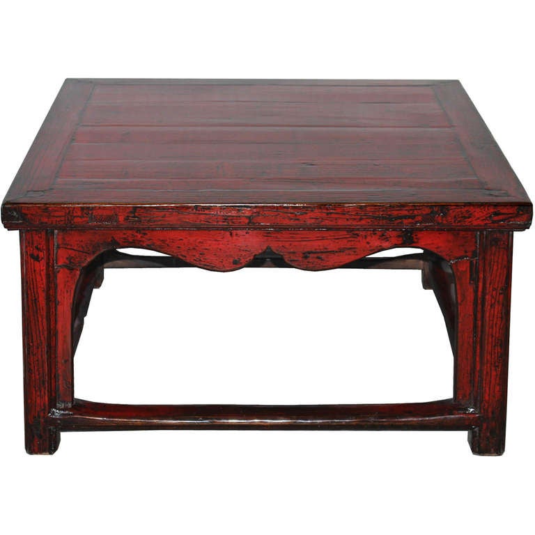 Square red lacquer coffee table with scalloped spandrels and bottom stretcher bars. Beijing, China circa 1890s.