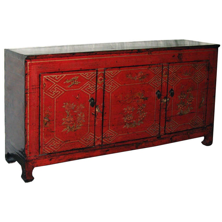 Antique red lacquer wedding buffet with hand painted flowers and birds on three doors. Red color symbolizes happiness for the newlyweds. Ample storage for dishes or entertainment equipment. New hardware and interior shelf. 
