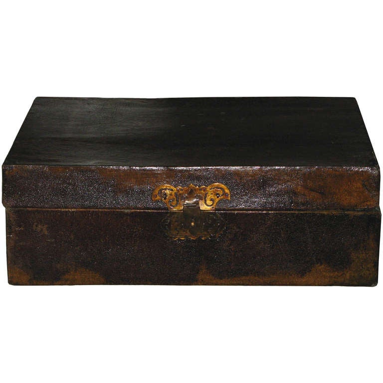 Antique leather box with original butterfly hardware was used as a traveling suitcase. Well preserved inside lining shows original oiled paper. New back hinges, circa 1880s.