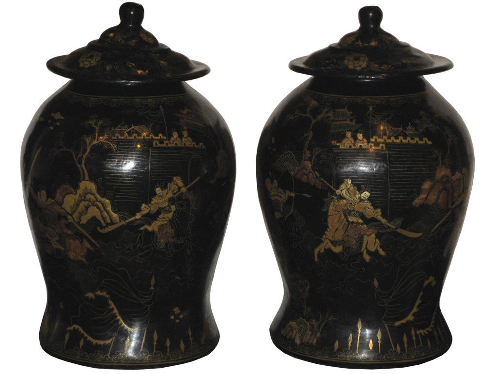 Pair of vintage papier-mâché black and gold ginger jars with lids. Hand painted gold chinoiserie scenes of warriors demonstrating their skills using martial arts weapons.
