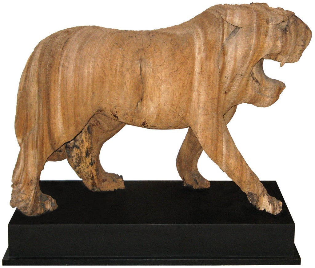 Antique hand-carved teakwood tiger from Burma. Beatutiful wood grain and texture. Mounted on a black stand.