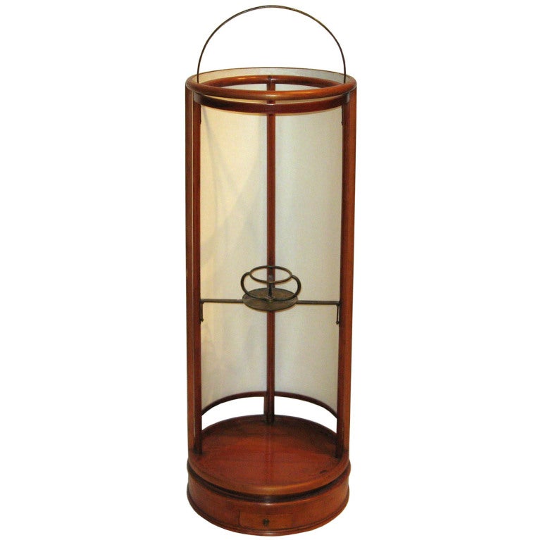 Taisho period Japanese andon (rice paper lantern). The amount of illumination can be controlled by sliding the rounded rice paper panel. Bronze candleholder is in the interior center with a small drawer to hold matches at the base of the lantern.