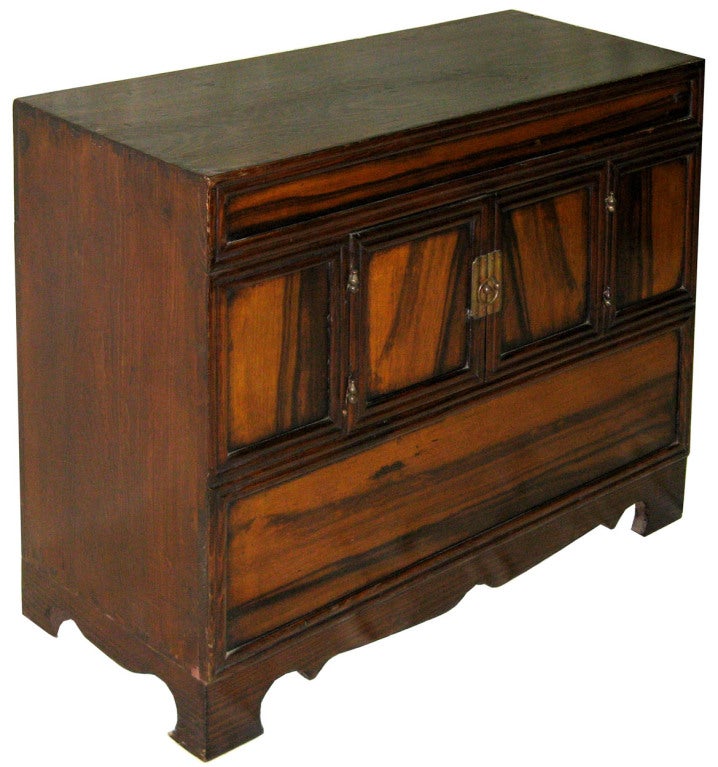 Vintage 1920s Korean persimmon wood headside chest, used in the bedroom for personal accessories.
