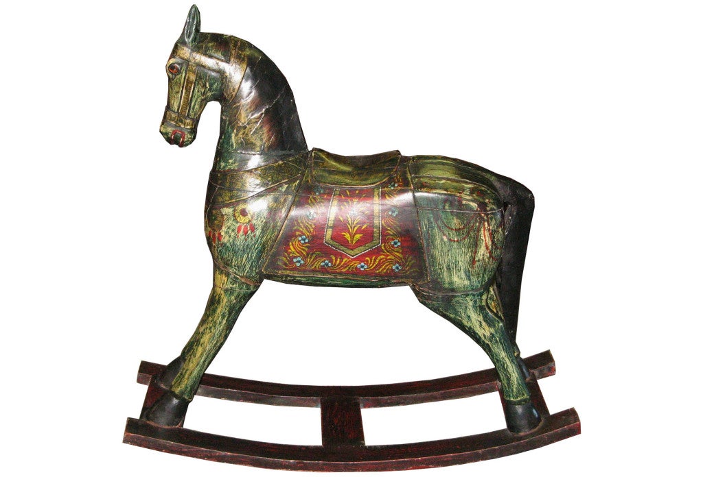 Vintage hand painted wood rocking horse made by artisans from Jaipur, India. Colorfully painted rocking horse was used by families to entertain children in northern India. Circa 1950.