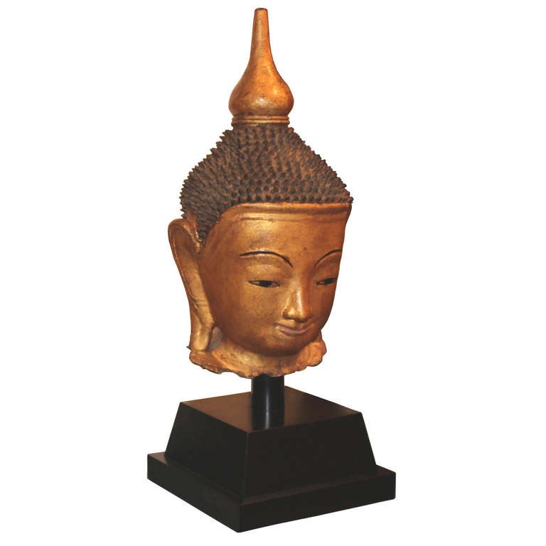 19th century traditional gold lacquer Buddha head on custom stand comes from the Shan ethnic group. Display on a console table to welcome guests. Burma.