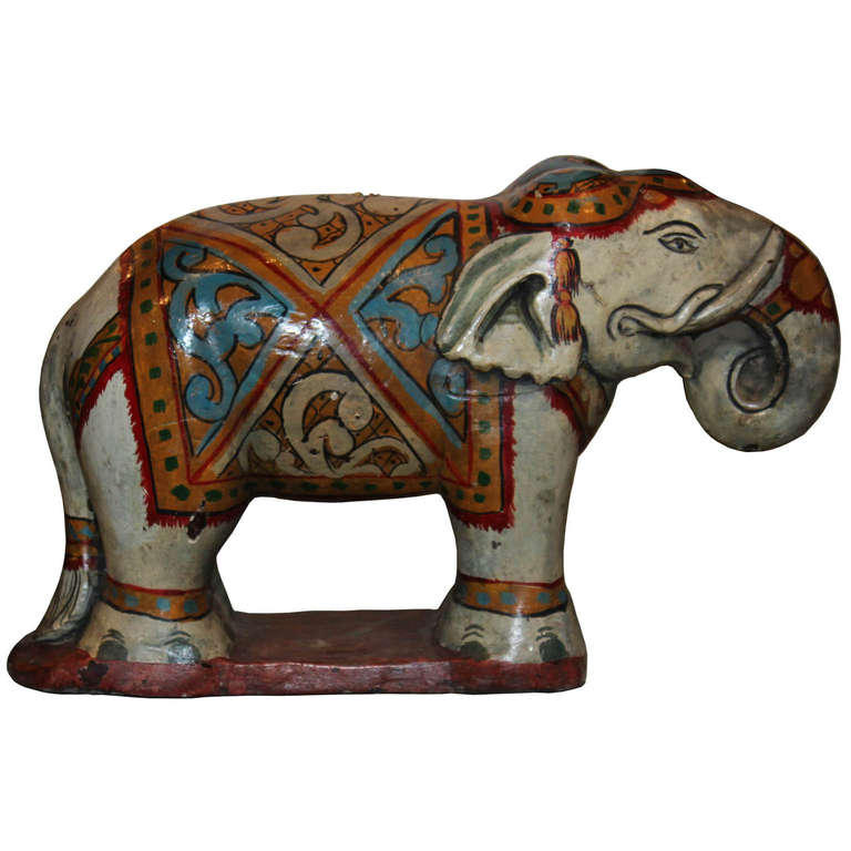 Hand-painted wood elephant with regal ceremonial clothes would be a colorful accessory for a bookshelf or coffee table.