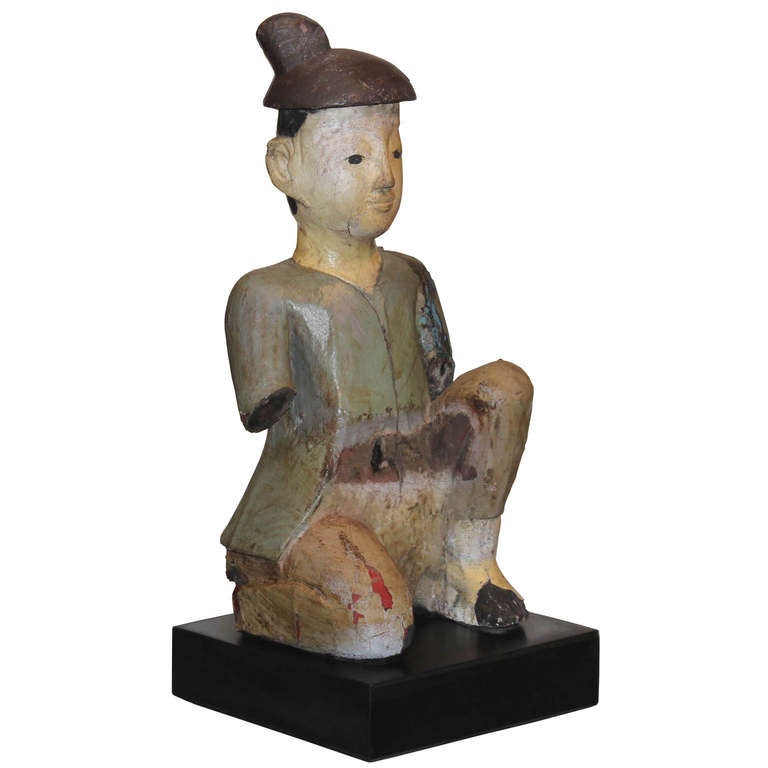 Hand-carved teakwood Burmese nat in traditional clothing represents Burmese spirits.