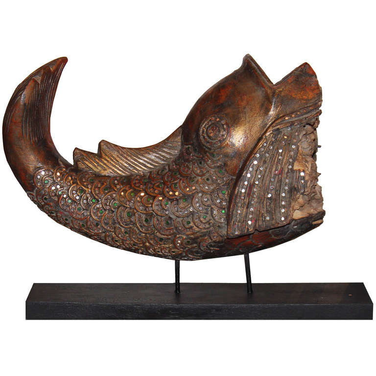 In Asia, fish represents abundance, wealth, and prosperity. This Burmese fish is decorated with colorful glass eyes and scales, typical of Mandalay style lacquer carvings. Good luck Feng Shui accessory to place at the entry or on a console table,