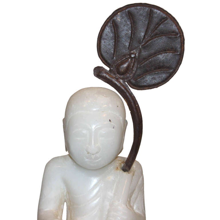 Small alabaster 19th century Burmese traveling monk holding a copper palm leaf would look beautiful on a bookshelf.