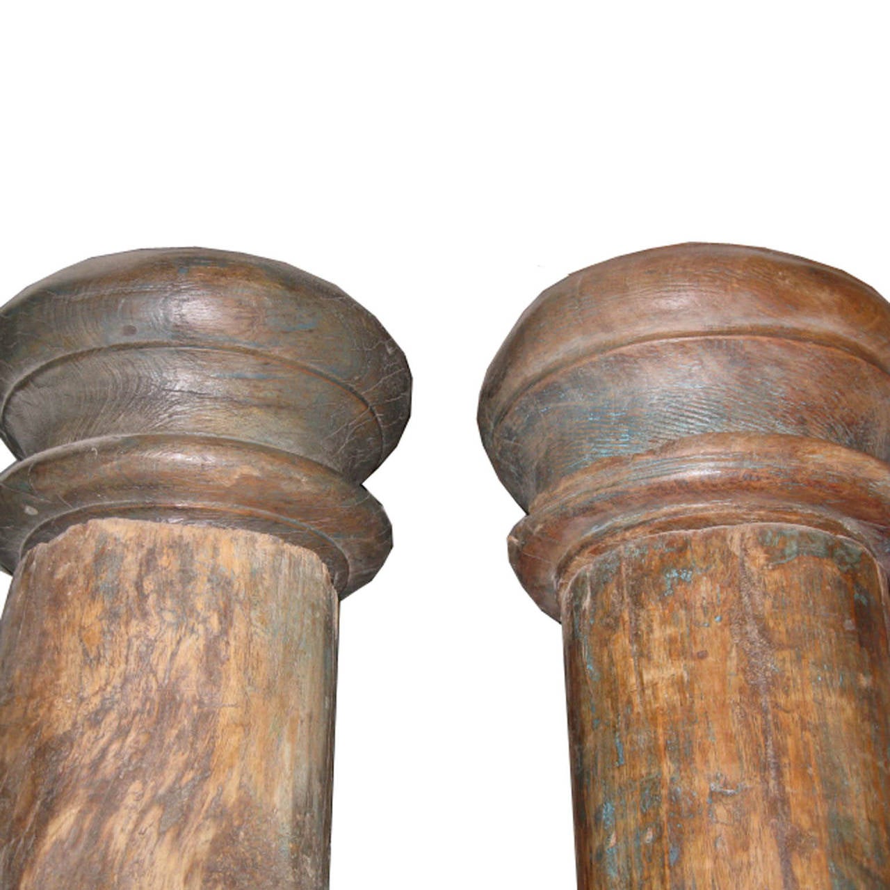 Pair of beautiful wood columns from a Haveli in Gujarat, India. The columns have rounded wood capitals and stone bases. Originally used to adorn an entry in a traditional Indian Haveli. Assembly required.