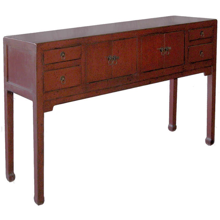Red lacquer Chinese altar table or console from the 1890s, with elegant horse hoof feet. Multiple drawers and doors for ample storage. New interior drawers and hardware.