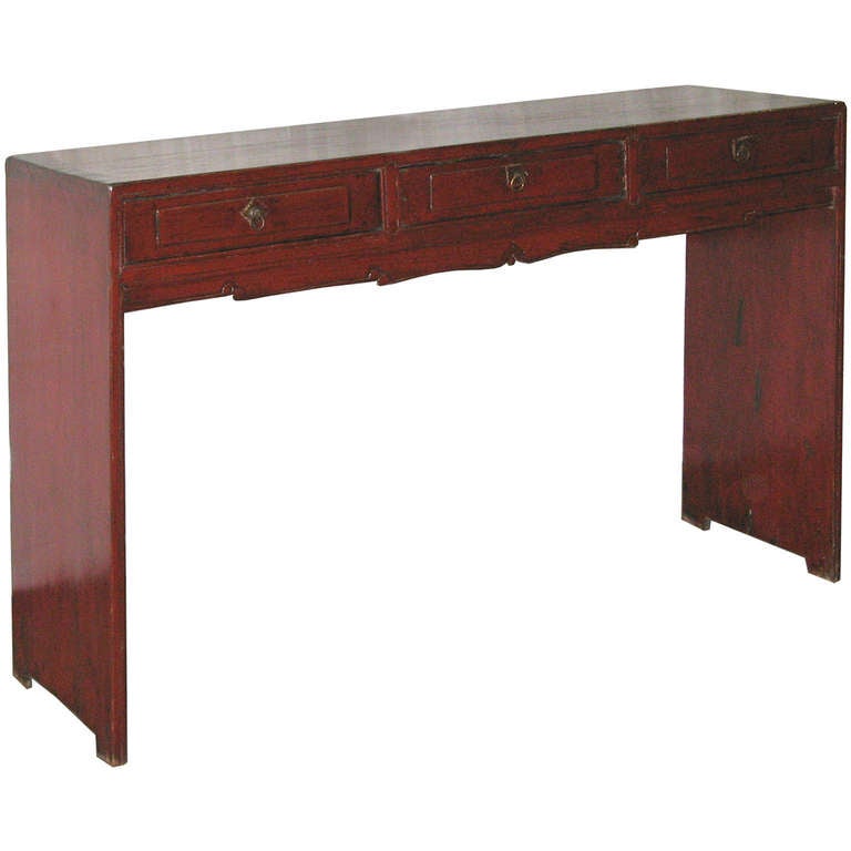 Elegant red lacquer console table with scalloped skirt and three paneled drawers. New hardware. Circa 1890s.