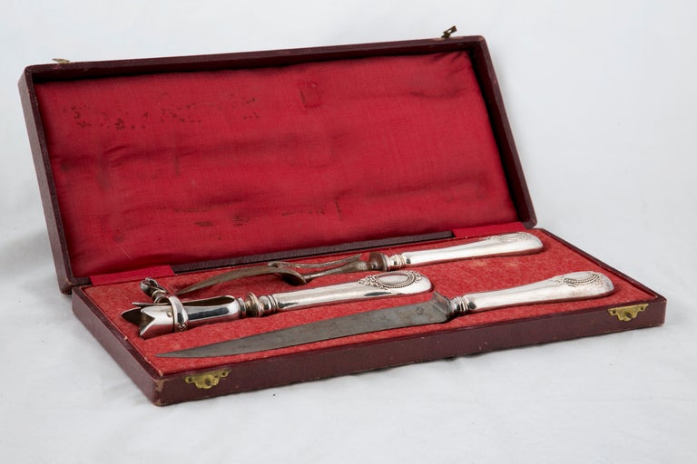 Three piece (carving knife, fork and bone holder) silver plate set in original fitted case.
