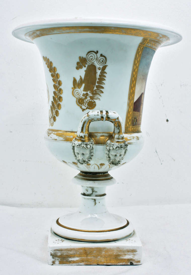 A rare Paris porcelain French large urn commemorating Napoleon Bonaparte, circa 1840. The piece is particularly special because of its size. The faces adorning the side are of Bacchus, Roman god of wine. The quality of the decoration is exceptional.