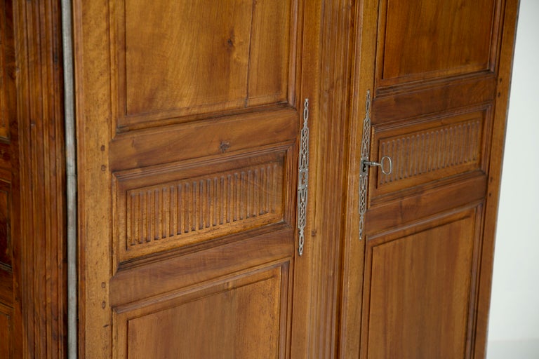 A large simple elegant and large Louis XVI armoire or cabinet made in France of fruitwood during the 18th century. Fantastic storage. The interior can be fitted out in any manner you wish. Shelves drawers cabinets for stereos and televisions. When