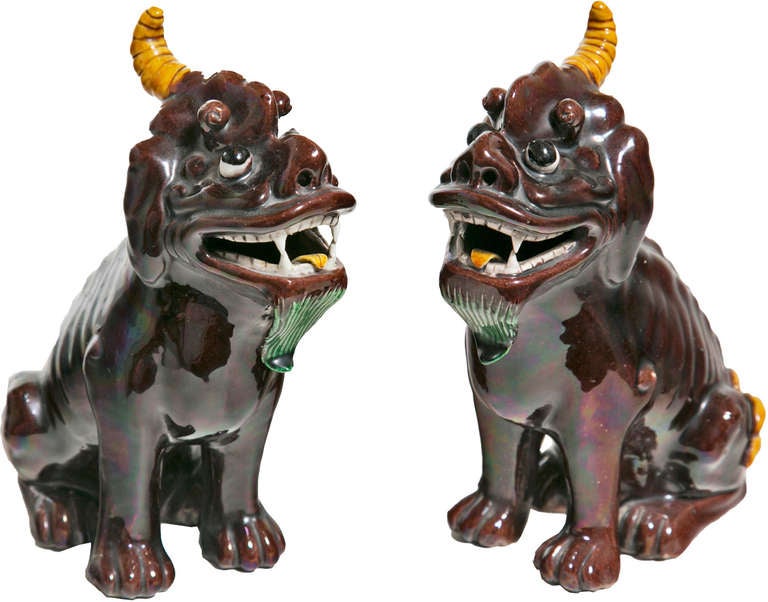 Made in China, circa 1920s-1930s. Covered in aubergine glaze in porcelain. Each kylin dog seated on its haunches with open mouth and green beard.

From the collection of R. F. Schwarz, a seasoned dealer of fine porcelain and objects, leading