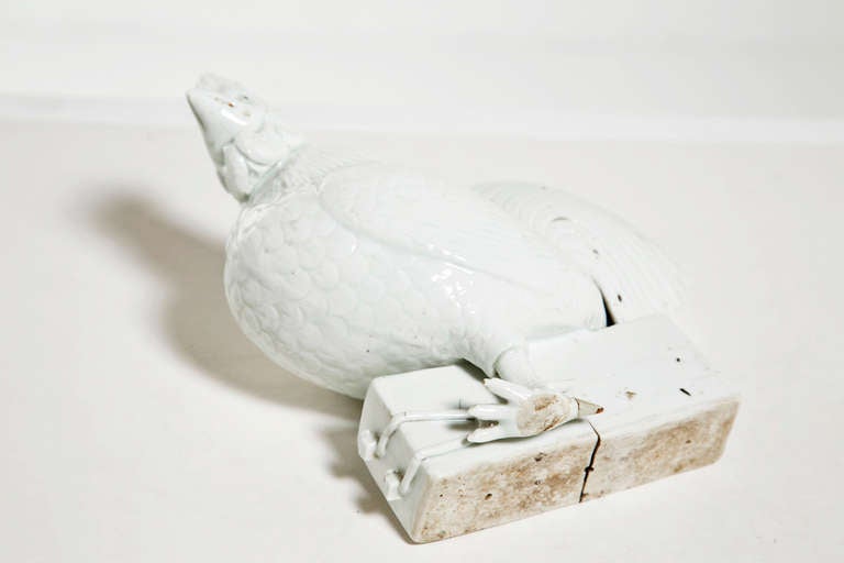Well worked figure of a white glazed ceramic rooster standing on a brick.  Made in Chin circa 1820.

From the collection of R. F. Schwarz, a seasoned dealer of fine porcelain and objects, leading designer on the West Coast for decades and an