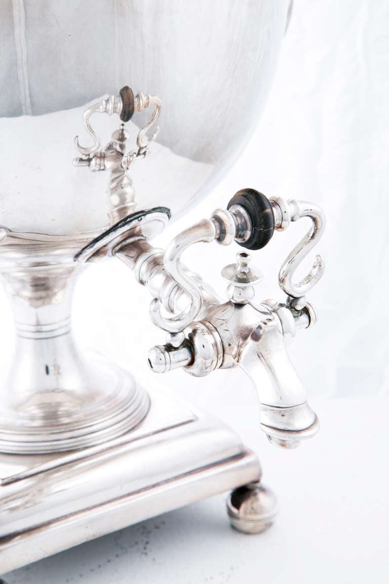 A classic Regency design sheffield plated hot water made in England during the first part of the 19th century.  Incorporating many neoclassical motifs, most notably gadrooning.  The urn stands on four spherical feet.