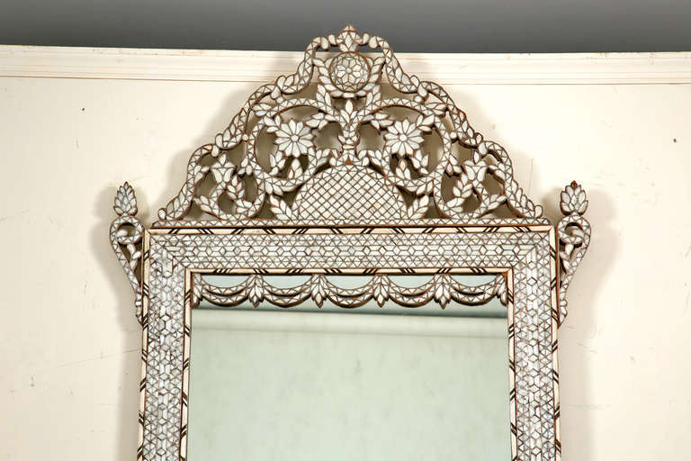 A wonderful old Moroccan mother of pearl inlaid mirror inlaid with white metal, bone and wood.  Mirrors like these where popular in the Ottoman era and have been made for hundreds of years.  We think this one was made early in the last century.