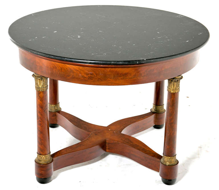 A large and chic Louis Philippe period mahogany table with ormolu mounts and a black marble top.  Tables like these originally stood in the center of formal rooms or entries and held plants, sculptures or flowers.  They where meant to impress and