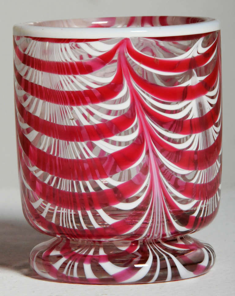A rare English glass tumbler by Nailsea made about 1840.  White and red swirls over a clear ground.    3.5 inches tall