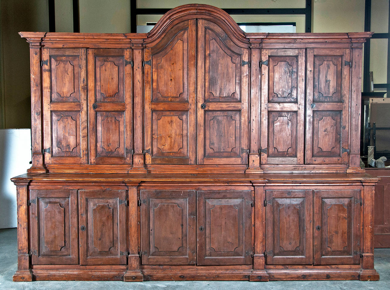 A massive Baroque style cabinet made in the Spanish Colonies about 200 years ago. Incredible interesting storage piece with great design and rustic appeal. We think it is made of some soft wood like pine but the grain of the wood is more